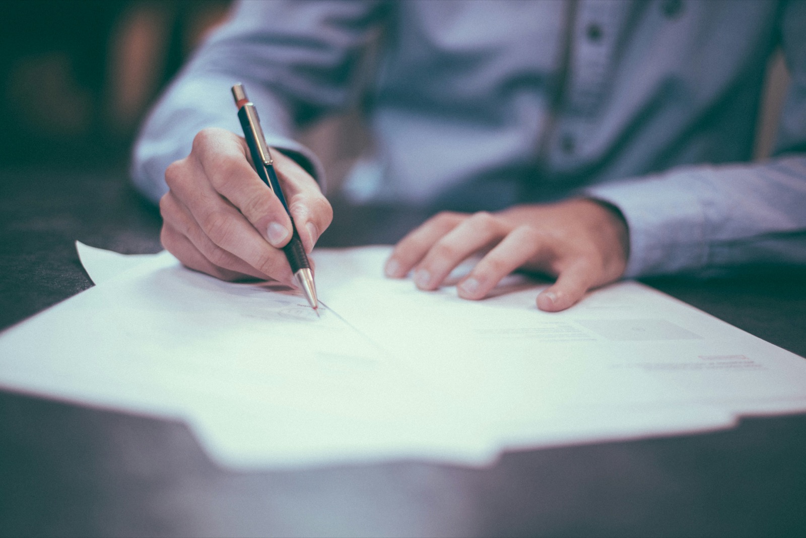 Legal professional reviewing and signing documents